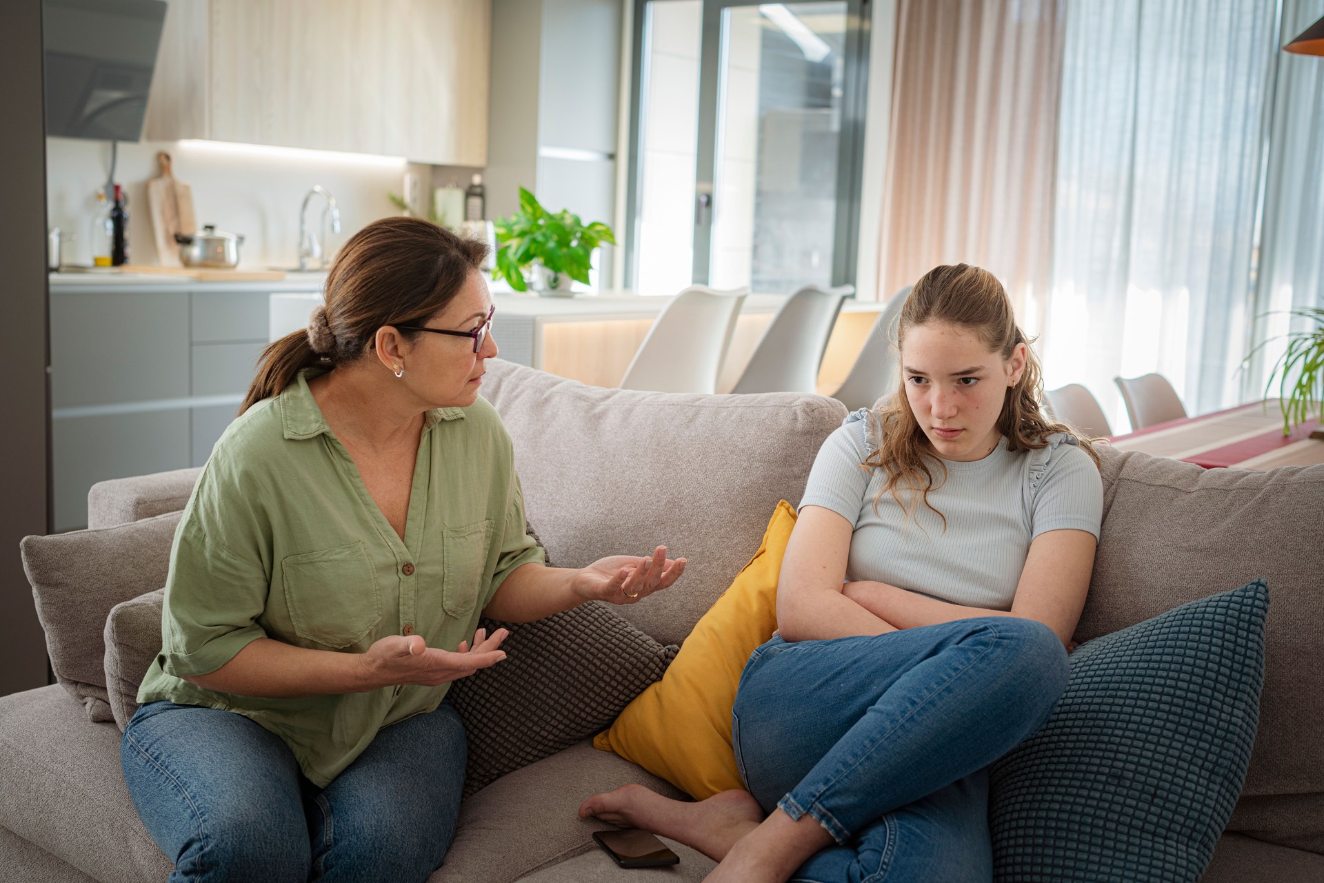 Mother talking to offended adolescent daughter